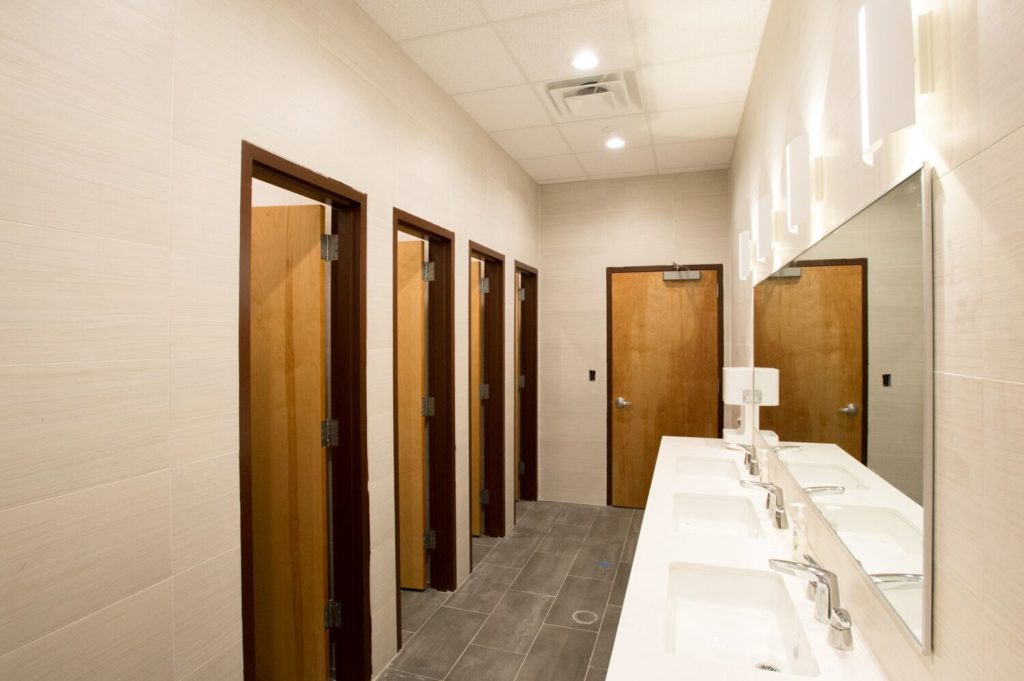 Restrooms at Annex 302 with private stalls and a shared vanity