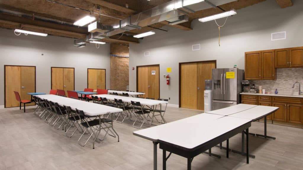 Break room at Annex 302 with crew seating, kitchen counter and refrigerator