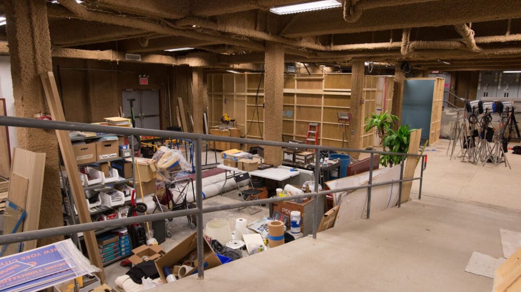 Shop space at Annex 302 with workbenches, lumber storage and build materials