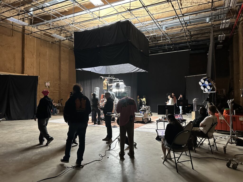 Film crew shooting on South Stage at Annex 302 in Brooklyn beneath a large overhead silk