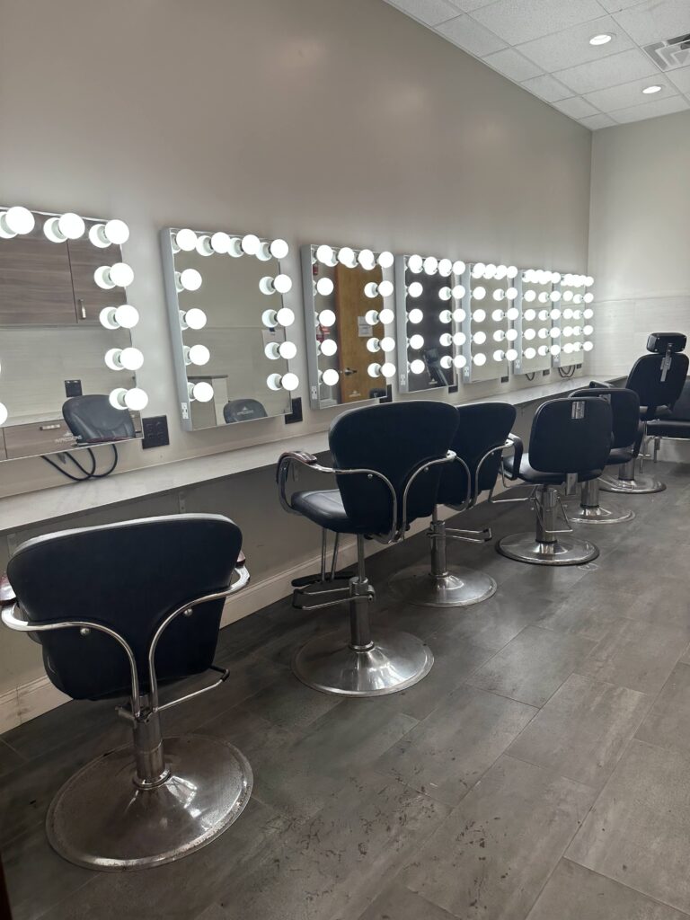 Row of seven hair & makeup chairs with vanity mirrors